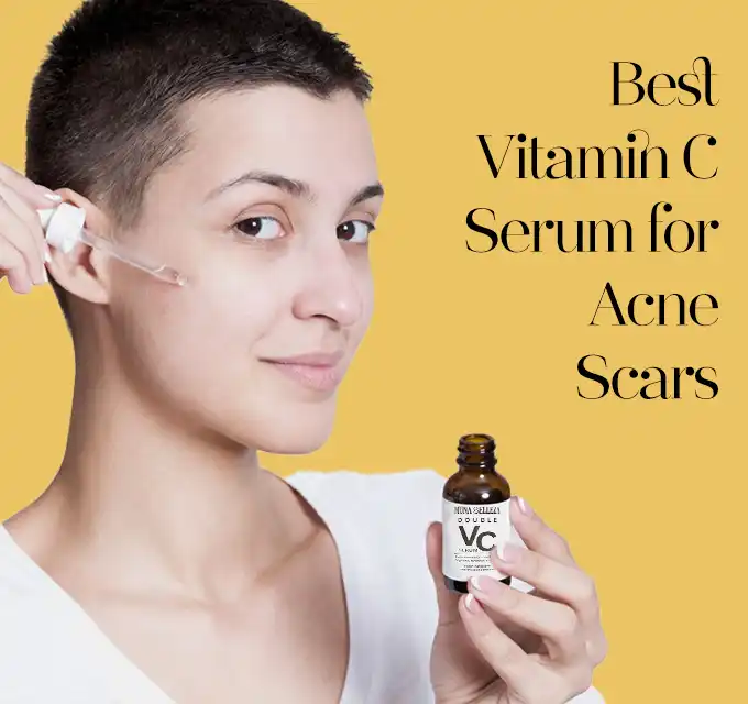 Person with short hair smiling slightly as they apply a vitamin C serum drop from a pipette onto their cheek while holding the bottle, yellow background